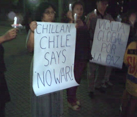 Nora holds a sign-- written in English to get the point across to GW Bush.