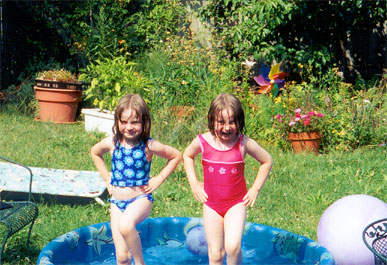 Emma and Madelaine in the wading pool, doing River Dance