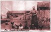 Ingeborg Ougendal feeding the chicken in the Ougendal courtyard, around 1925