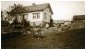 Gunder and Ingeborg poses in front of the house while Georg looks after the cows and Ida sits in front of the old barn. Ida had put the year 1925 on this picture in her photo-album. Another copy was found among Hans Kristian's belongings, with words of great compliment written by Ida on the back of it. She probably missed her brothers and sisters living so far away from home