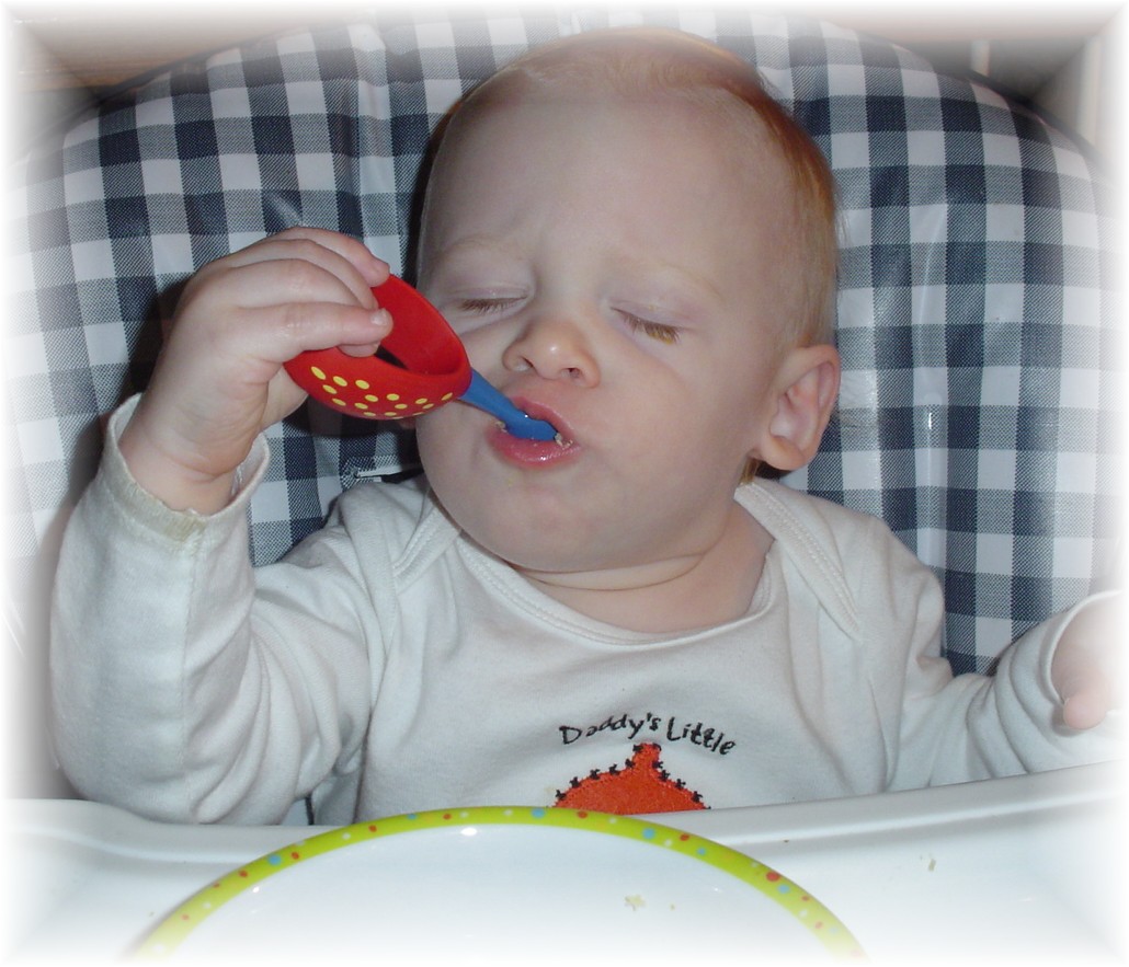 Aidan eating with a spoon