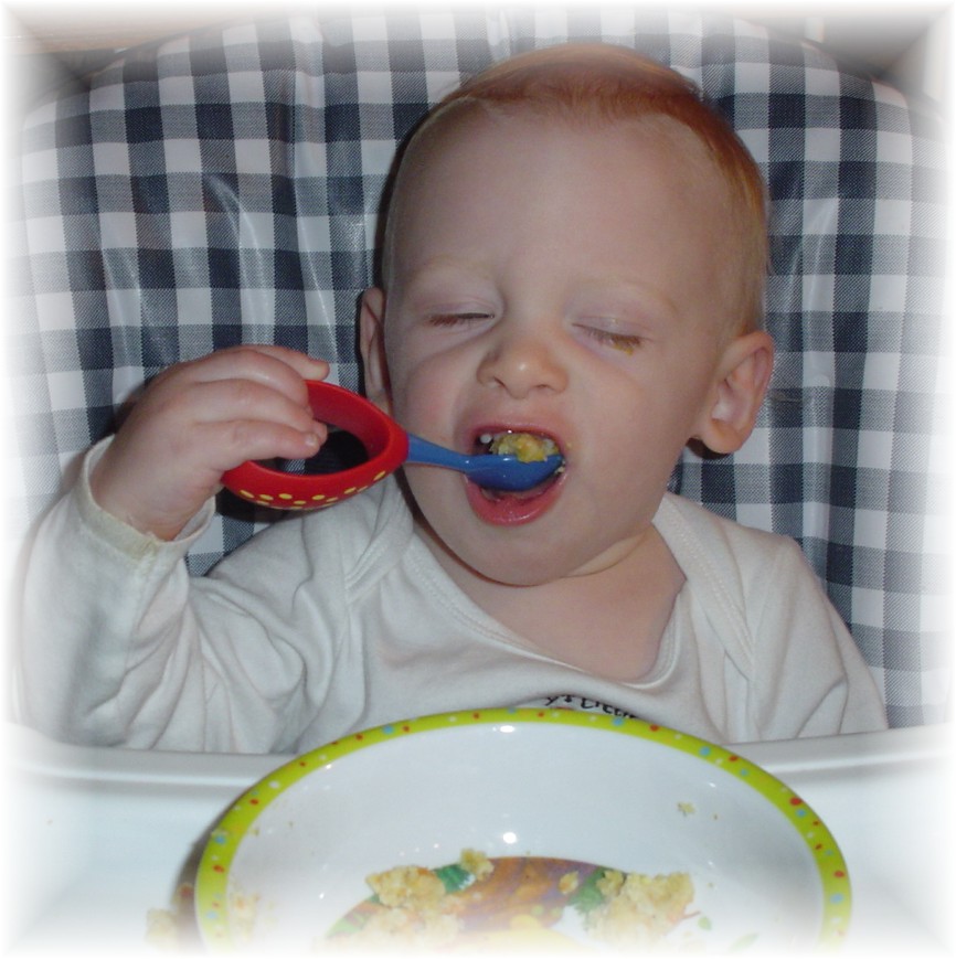 Aidan eating with a spoon