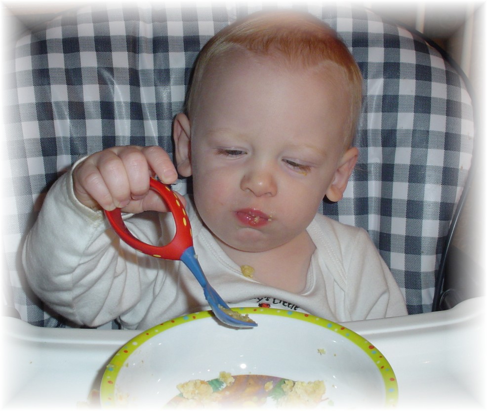 Aidan eating with a spoon