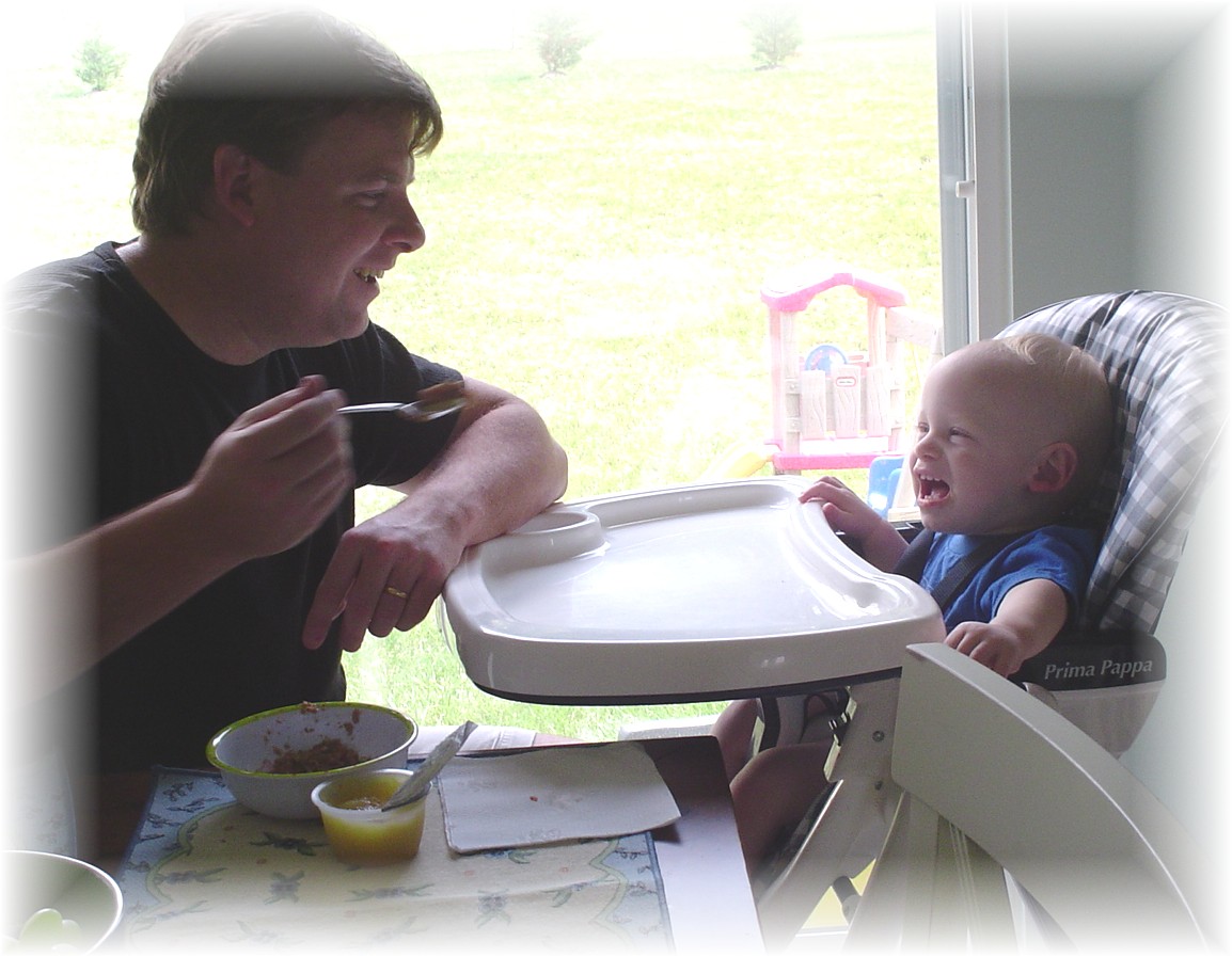 Daddy feeding Aidan and doing the "fake laugh"!