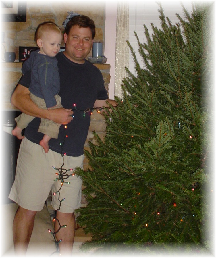 Daddy and Aidan putting on lights