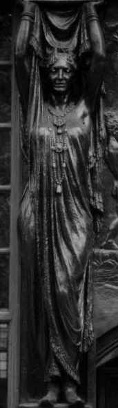 statue on a building by Trafalgar Square