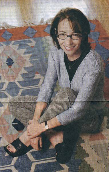 Here's Ms. Packer Sitting down on her Southwestern Style Rug