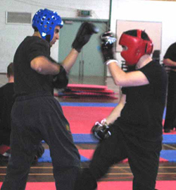 Andrew (in red) scores a point for a shin kick during continuous sparring bout.