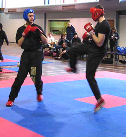 Ollie (in red) prepares a front kick during continuous sparring bout.