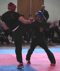 Ollie (in red) gets a point for a round house kick during point sparring bout.