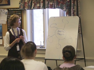 Delegation Leader Jane Mueller providing instruction about several methods of effective note taking for journaling. . . and delegates intently listening