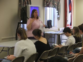 Delegation Leader Mrs. Foster guides those presenting . . . 