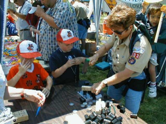 Cub Scouts helping visitors make a flute of their own at Scout-o-Rama 2001 at Kennedy Park in Hayward