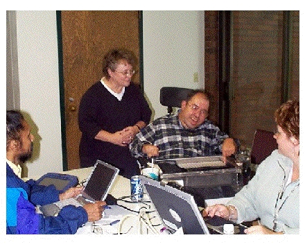 Scott demonstrating his AAC device to people