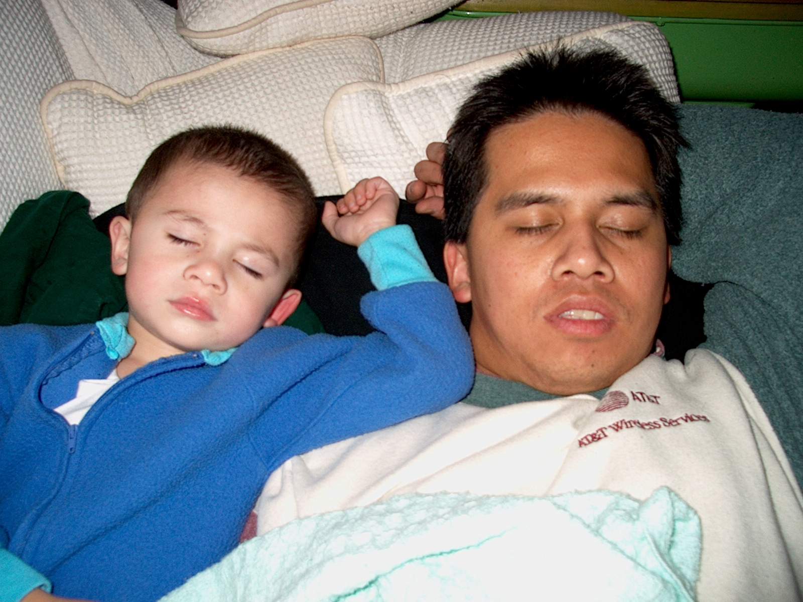 After a full day of playing, father and son take a nap