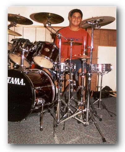Micah plays on a TAMA drum set