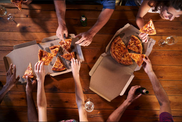 hands grabbing pizza