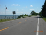 Between Youngstown and Rochester Hwy 18 runs right along the shores of Lake Ontario for long stretches. This is an extremelly flat, quiet route with very light traffic and few services.