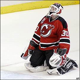 The Devils' keeper (Brodeur) looks dumbstruck after conceeding a weird goal