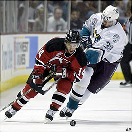 2 players chasing the puck