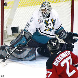 The puck bounces off the post (see top left of pic)