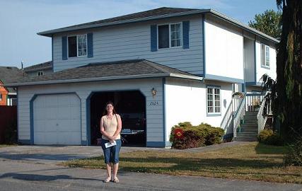 Lisa in front of house