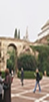 People walking through the courtyard in the palace in Seville