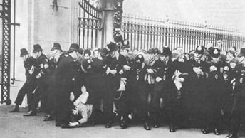 Investiture: police hold back the crowd as the Beatles prepare to leave Buckingham Palace after receiving the MBE