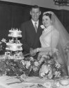 Cutting the cake on thier wedding day.
