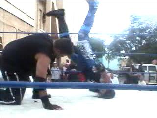 Pico throws DBK towards Barbed-Wire