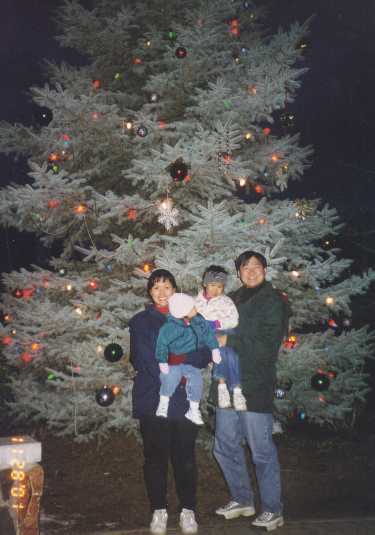 The family by the town Christmas tree