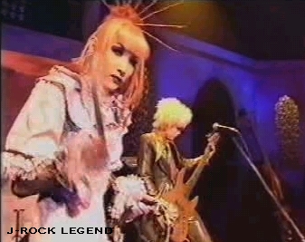 Mana-sama glaring at the camera with a fuzzy drumstick, & Yu~ki-sama jamming bass in the background...