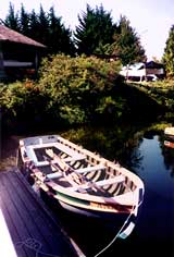 Rowboat tied at pier in late afternoon