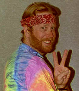 me with red bandana headband holding two fingers up as piece sign