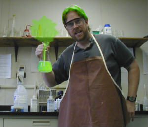 Me with green hair holding a beaker of green stuff with green smoke coming out