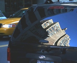 reflecton of a NYC building in a car window