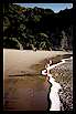 Surf's edge and cliffs at South Piha in front of holiday house Auckland New Zealand