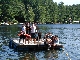 Staff and Villagers on Raft