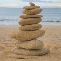 rock cairn at beach photograph