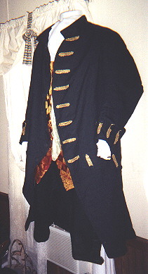 Green linen frock coat with gold braid trimmings fabric covered buttons