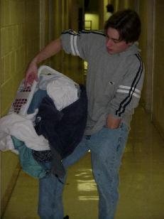 Buffoon dropping laundry while reaching for keys
