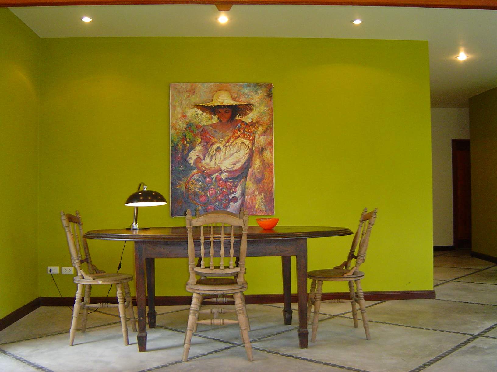 the dining area with oval table and six wooden chairs