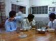 Students having dinner at Hostel Mess and also watching TV
