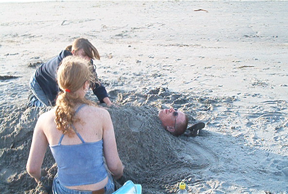 Me buried in sand, again at Shallow Bay.&nbsp; The best beach on the island