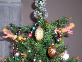 tree with antique glass ornaments and wax figures