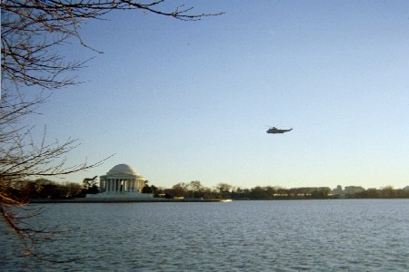 The Marine One flying over the Potomic River in front of the Jefferson Memorial