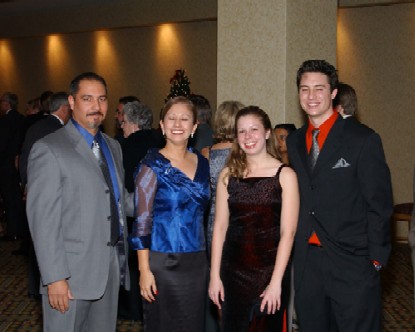 Julia's husband, Julia, Me, and Toby all posing for the camera at our company's Christmas Party at the Radisson Hotel.