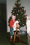 Peter Melrose on rocking horse at Christmas