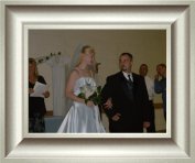 Heidi and Brett, newly wed, walk down the isle.