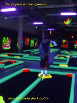 France plays a game of Black Light Mini Golf